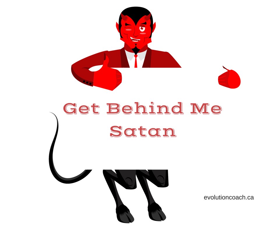 A cartoon figure of the devil. He is holding a placard and on it is written “Get Behind me Satan”.